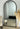 Dark wood Oakse arch mirror in a hallway