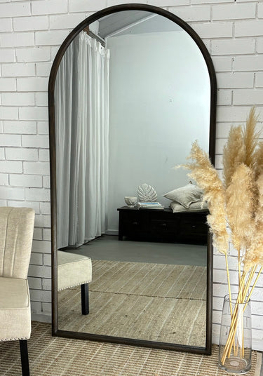 Dark wood Oakse arch mirror in a hallway