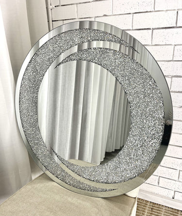 Crystal rounded gem mirror above a console