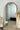 Oakse natural arch mirror reflecting a coastal interior