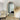 Wooden arch full length mirror in a bedroom