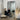 Thin frame full length mirror leaning against a wall