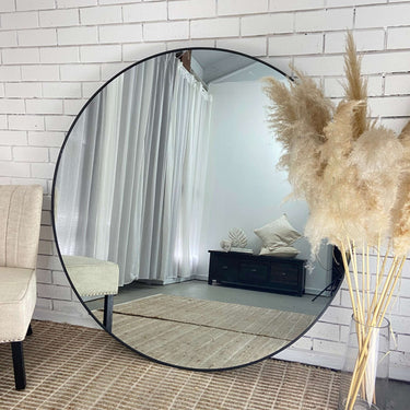 Wilson large round mirror in black on a wall in an entryway
