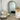 Light wood arch mirror in a coastal styled bedroom