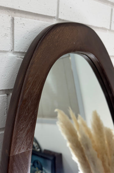 Pebble mirror in a natural wood finish