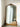 Primrose vintage rounded rectangle mirror in gold leaning against a wall
