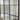 Window-style grid mirror reflecting a styled modern room