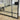 Window-style grid mirror leaning in a bedroom