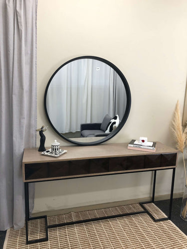 Black round wood mirror in a living room