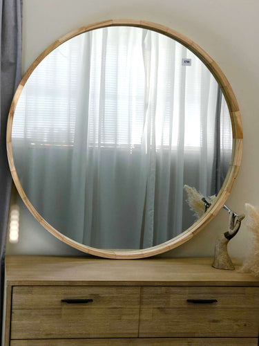 Milano round natural wood mirror on a wall