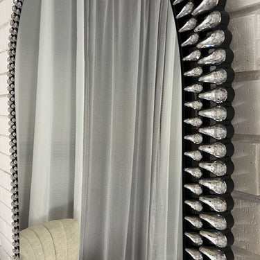 Diamond arch beveled glass mirror leaning against a wall