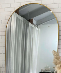 Small pill oval bathroom mirror above a vanity