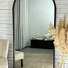Dark wood Oakse arch mirror in a hallway