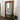 Extra large wooden mirror leaning against a wall