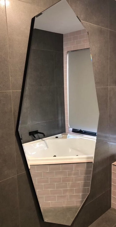 Geometric bevelled-edge mirror as a wall feature