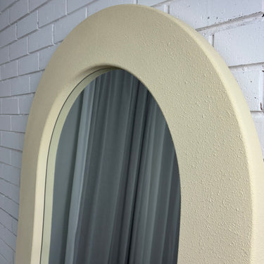 Off-white cream concrete-look mirror in a room
