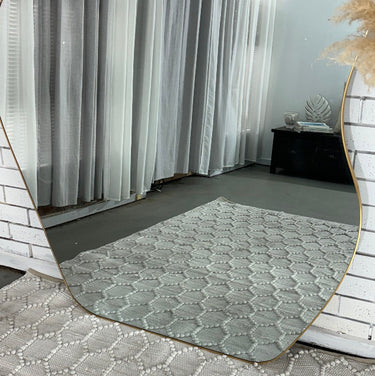 Retro wavy mirror leaning against a wall