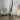 Gold freestanding arch floor mirror in a styled room