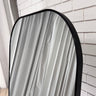 Freestanding arch mirror in a hallway