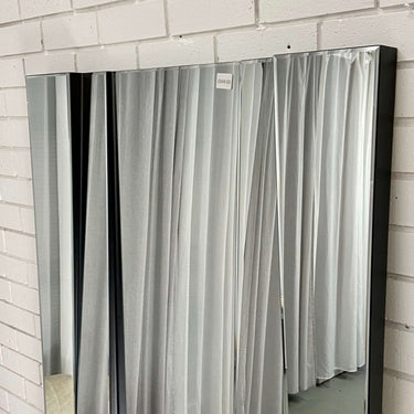Five-panel bevelled glass mirror with a black frame lining
