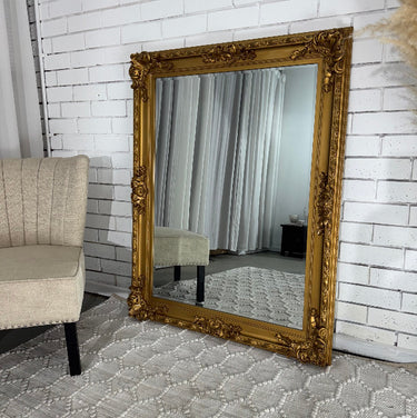 Antique gold French Provincial mirror above a mantel