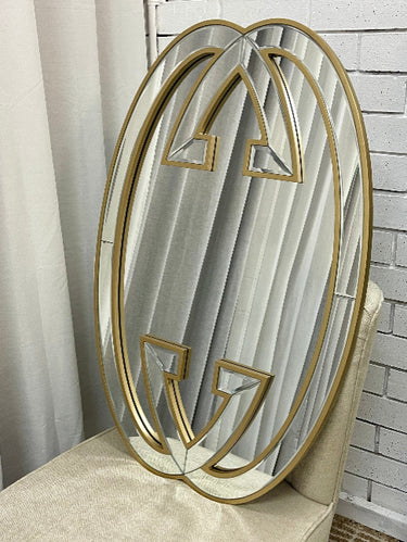 Gold decorative wall mirror above a console