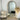 Light wood arch mirror in a coastal styled bedroom