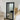 Black real wood mirror leaning against a wall