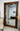 Large Milano wood mirror in a bedroom