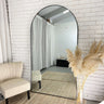 Extra large arch mirror in a living room interior