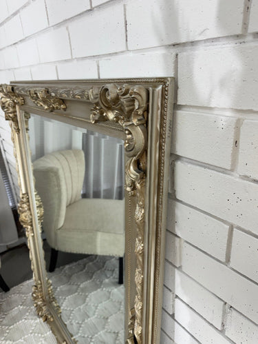 Champagne French Provincial mirror above a mantel