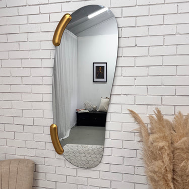 Atlas frameless organic wall mirror with gold accents, side angle