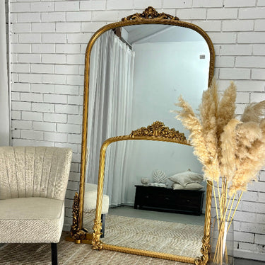 Gold Primrose mirror in a styled bedroom interior