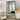 The Grid Mirror in black, industrial window-style metal frame leaning against a wall