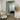 Gold rounded-corner mirror in a bedroom