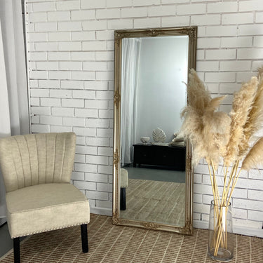 Vienna full length rectangle mirror in champagne leaning against a wall