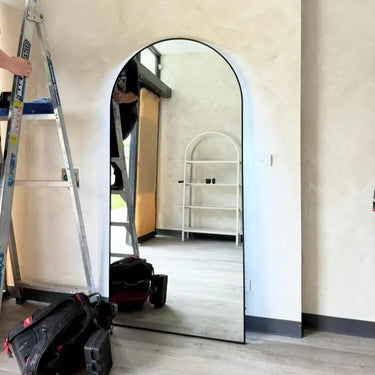 Black Luna LED arch mirror in a styled bedroom
