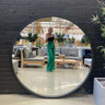 Large 120cm round wooden mirror on a wall