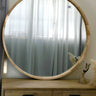Milano round natural wood mirror on a wall